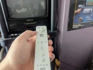 Hand holding wiimote in front of TV